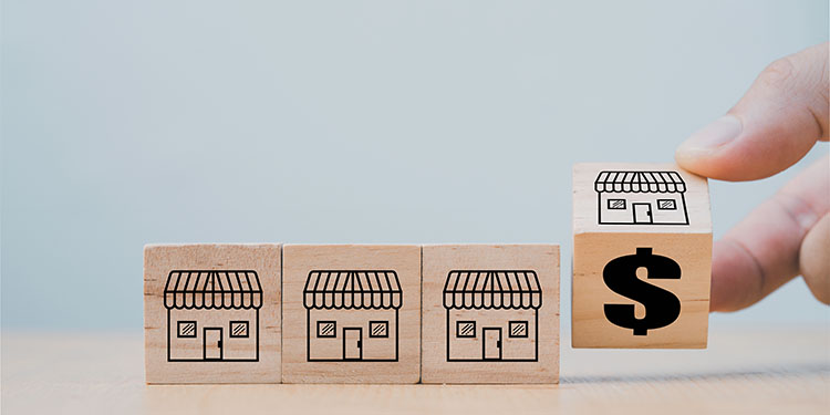 Franchising model depicted with wooden blocks.