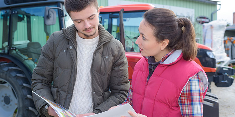 Business owner showing prospective buyer around business. 