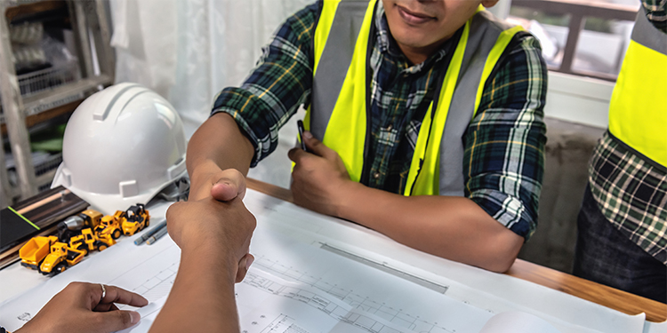 Construction contract employee receiving project details. 