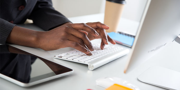 Person at computer researching financing options and the down payment requirements for buying a business.