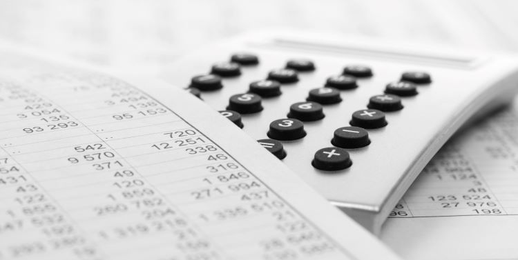 Calculator and printed financial documents. 