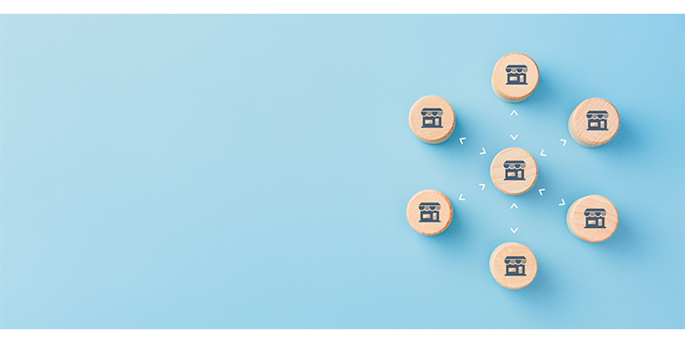 Franchising concept depicted with blocks on blue background.