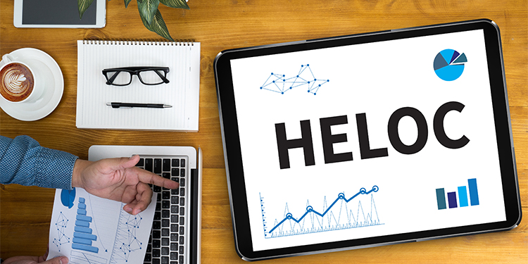 The phrase, HELOC, home equity loan, on a tablet.