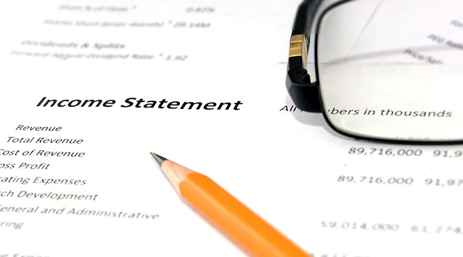 Income statements on desk. 