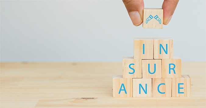 The word insurance spelled out on wooden cubes. 