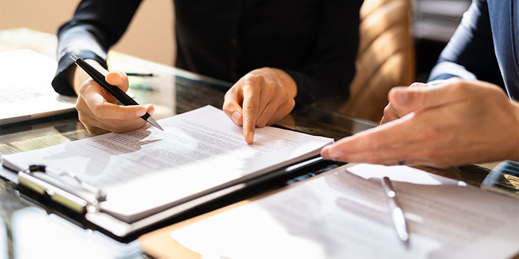 Legal documents for selling a business are being prepared and reviewed.