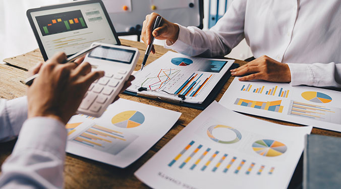 Balance sheet and computer screen illustrating liquidity and solvency of small businesses. 