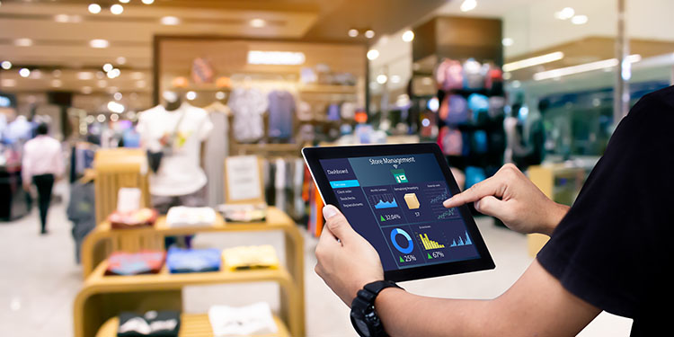 Retail worker using tablet to manage store inventory.