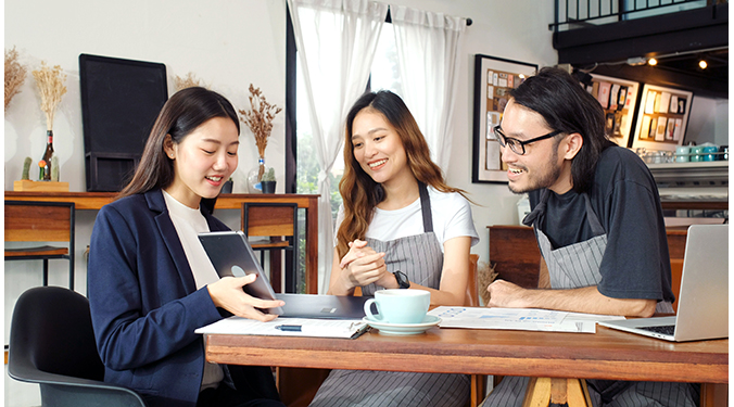 Small business owners of a cafe meeting with a business broker. 