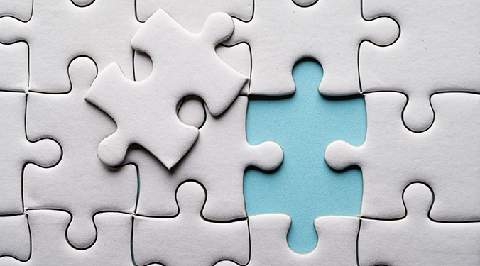 White puzzle with one piece removed, revealing blue background.