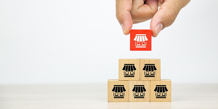 Multi unit franchise units depicted on wooden blocks. 
