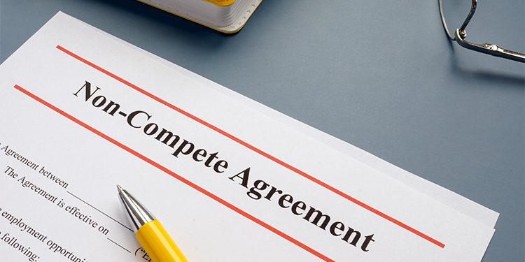 A non-compete agreement on a desk with pen.