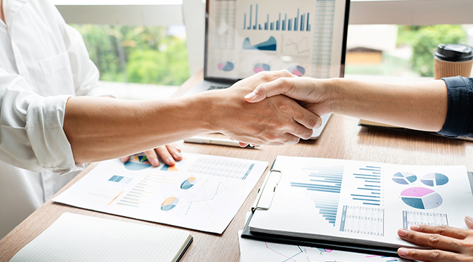 Off-market business transaction depicted by two hands shaking on deal.