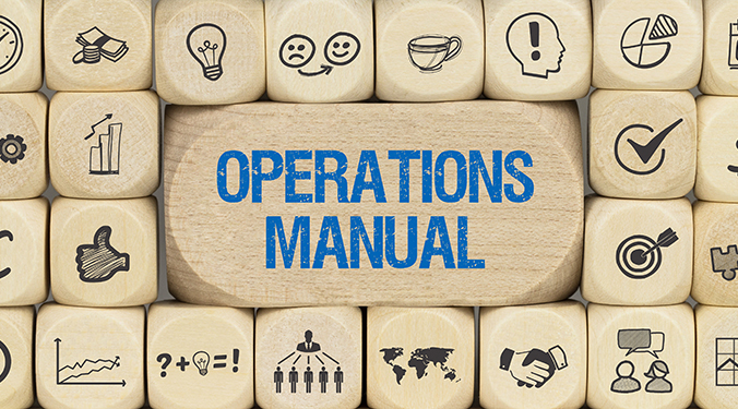 The term 'operations manual' printed on wooden block, surrounded by smaller blocks with operation icons. 
