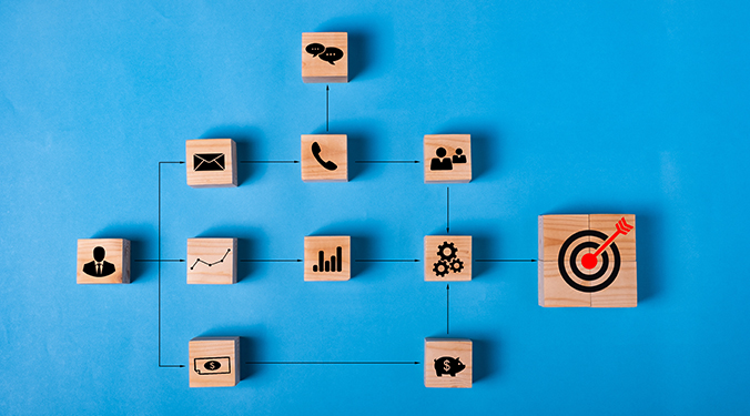 Business operations depicted with wooden cubes with icons for common business tasks. 
