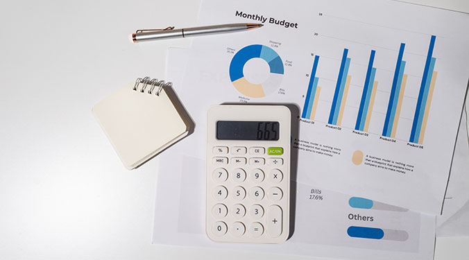 Calculator, spreadsheets, and notebook for keeping track of personal and business finances.