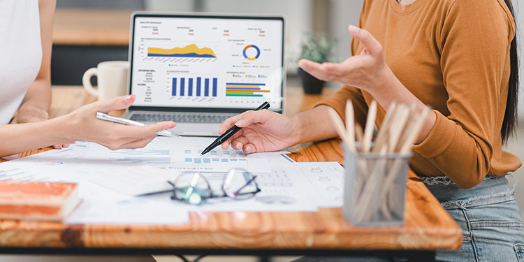 Business valuation metrics and charts displayed on computer.
