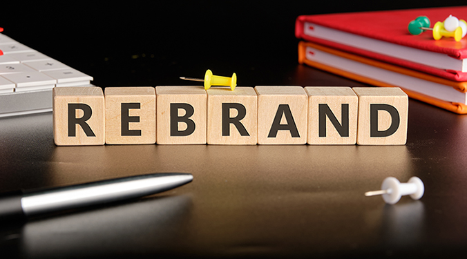 The word 'rebrand' spelled out on wooden cubes.