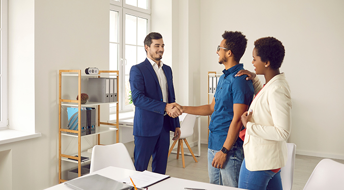 Business broker guiding business owners and shaking hands. 