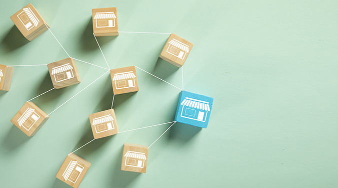 Franchise system depicted with wooden blocks. 