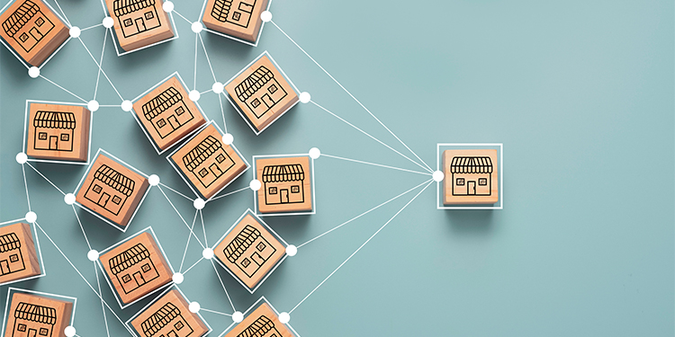 Franchise system depicted with storefront wooden blocks. 