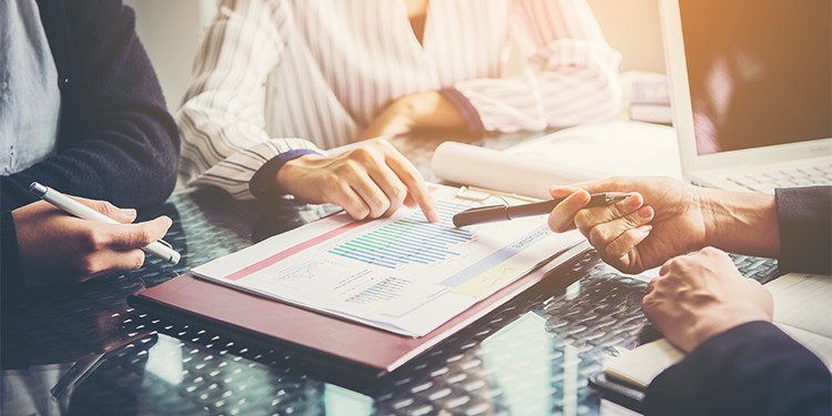 A computer keyboard with white keys and one blue key highlighting the word "holdback".