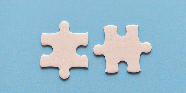 Two white puzzle pieces on blue background.
