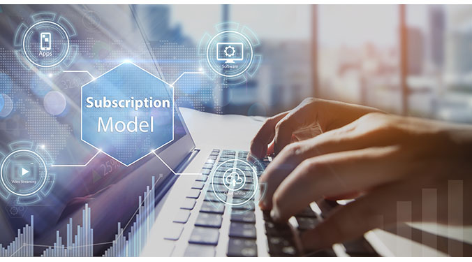 The words 'subscription based' with icons for business models overlayed on a laptop.