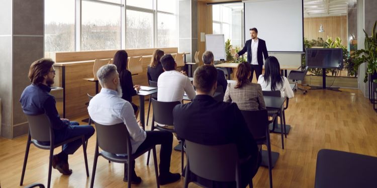 Business owner sharing information about sale of a business in conference room.