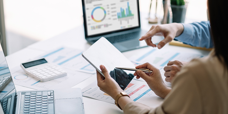 Business broker sharing tips and best practices in an office setting, using a tablet.