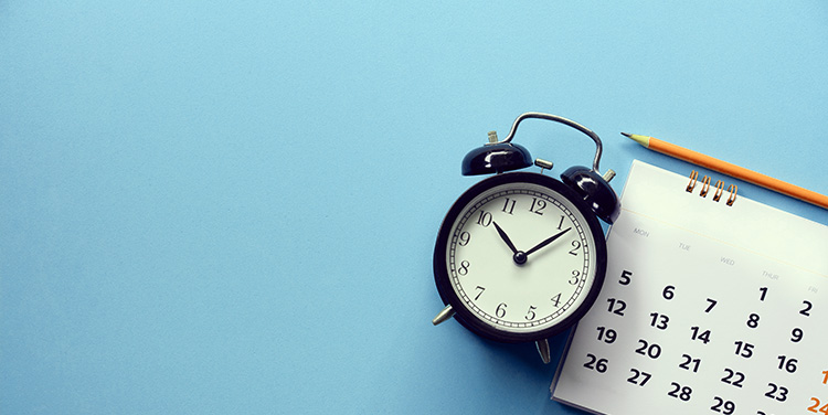 Clocks and calendars are merged together and blurred, depicting the timing of the sale of your small business. 