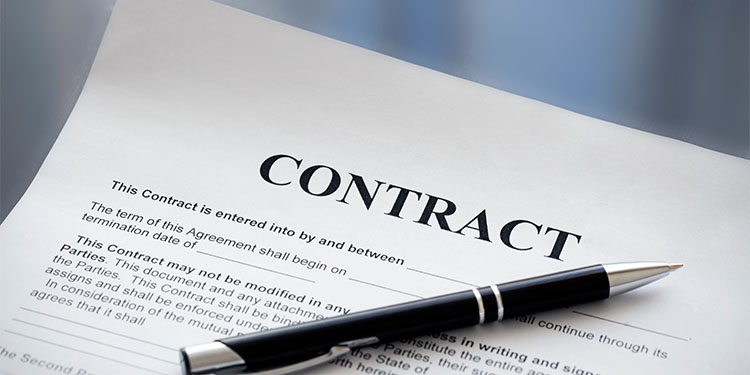 Contract document on a table with pen. 