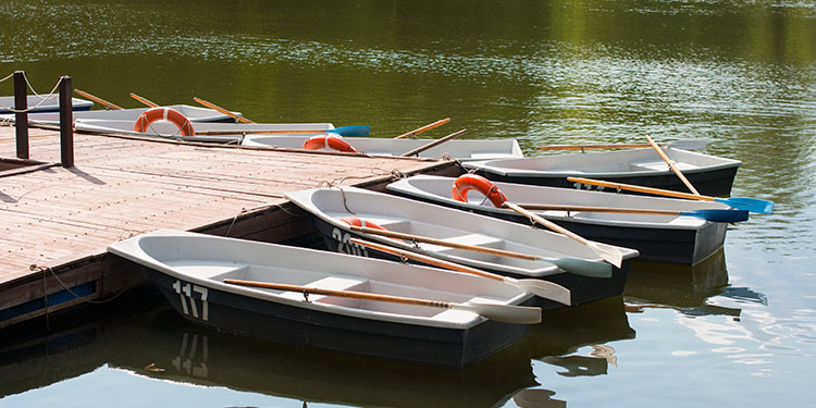 Boat rental company with row boats in lake.