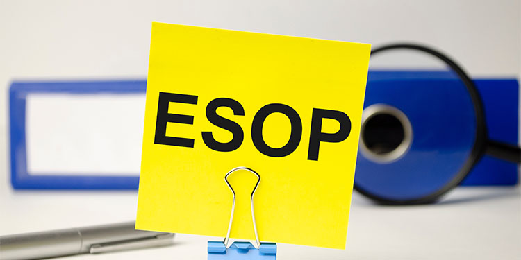 The term ESOP on a yellow post it note, on a desk. 