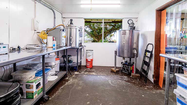 Sanitized production room with stainless tanks and bench-top equipment—ready for small-batch skincare blending and filling