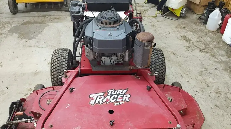 Foot activated Grass Flap to open and close grass chute on the fly