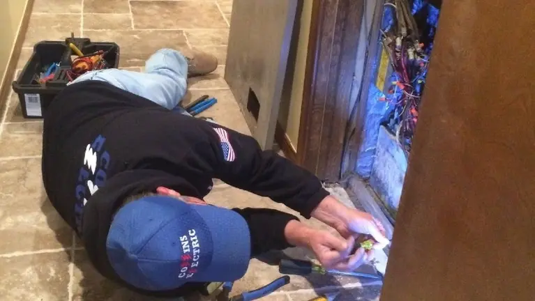 Troubleshooting a panel in tight quarters demonstrates the hands-on, service oriented work that drives steady income for Collins Electric.