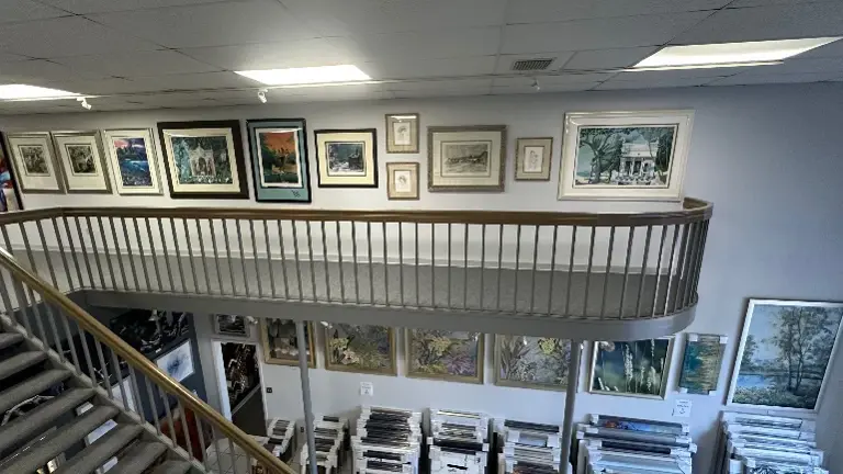 Framed artwork and loose prints in sleeves